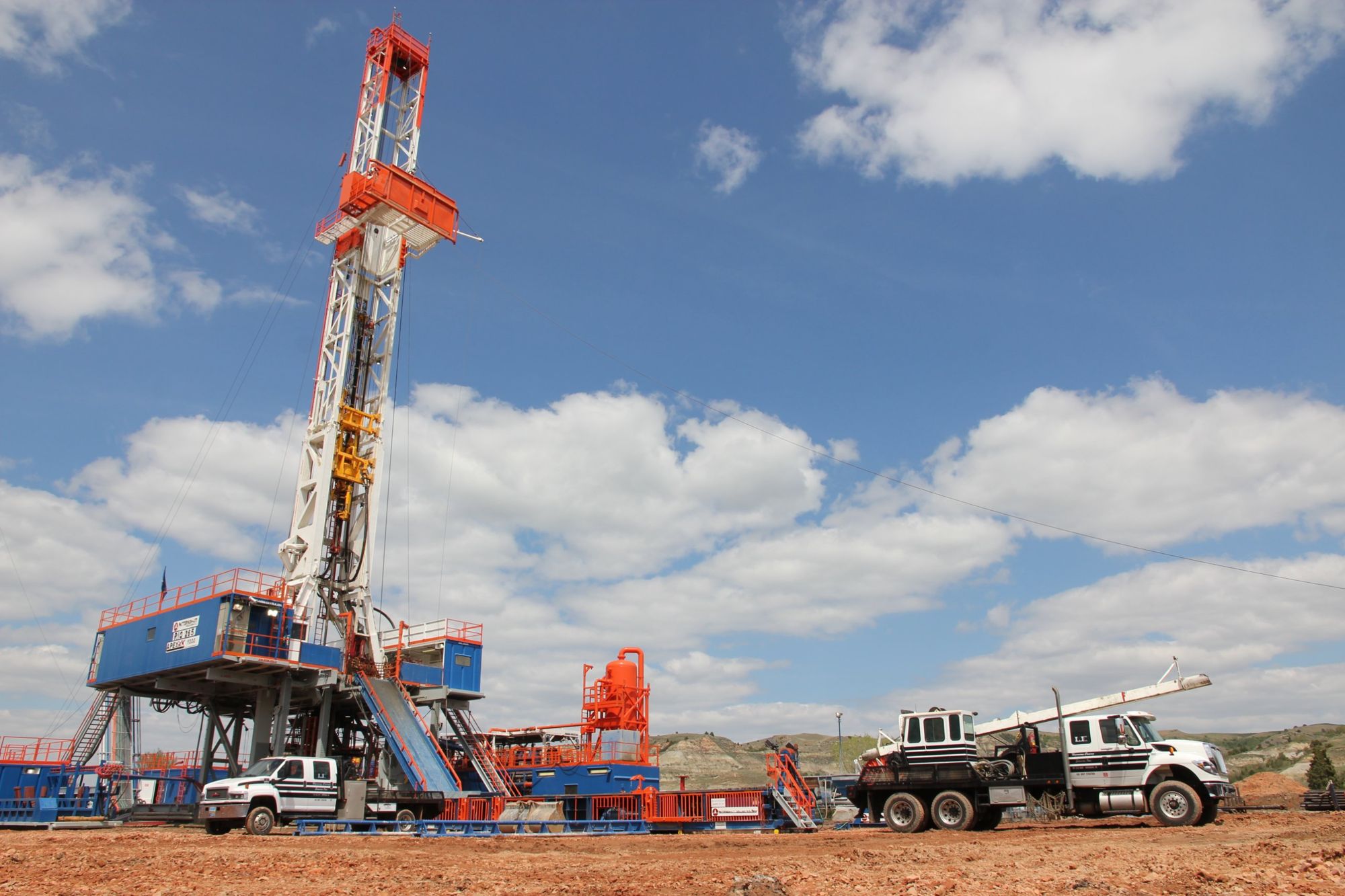 Drilling rig with service trucks on location